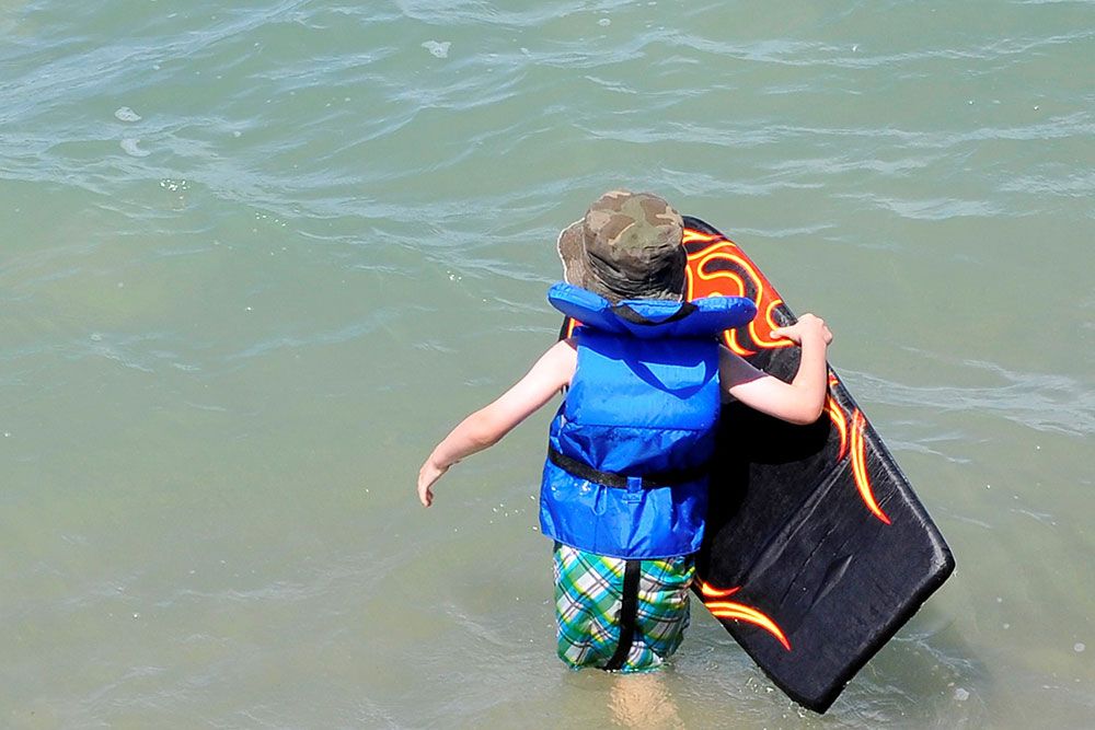 A photo of a boy ready to swim in Lake Huron.